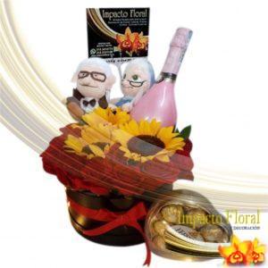 Caja redonda de rosas y girasoles con peluche con vino y chocolate ferrero