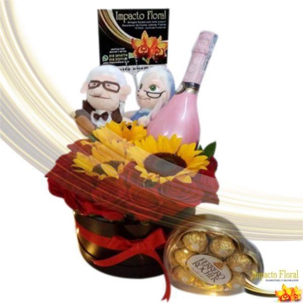 Caja redonda de rosas y girasoles con peluche con vino y chocolate ferrero
